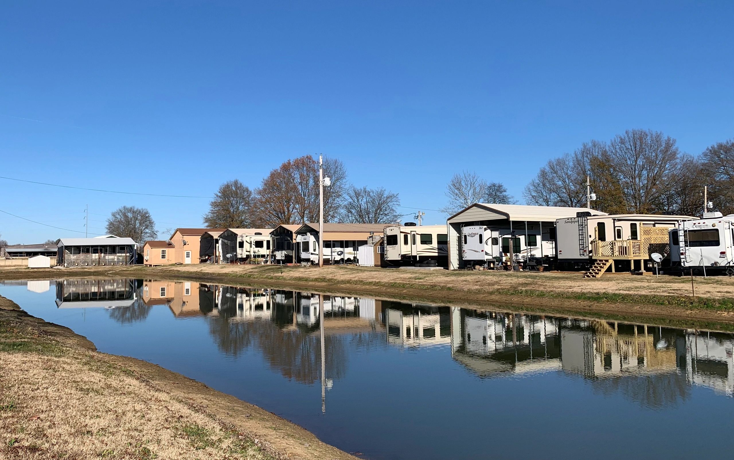 RV sites beside the peaceful pond at Casper Creek RV Park